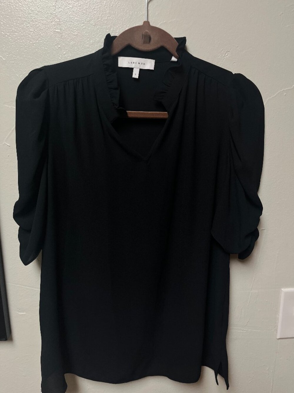 Lark & Ro black short sleeve blouse with ruffled v-neckline